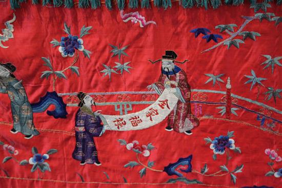 A Chinese embroidered silk red satin panel, early 20th century, approx. 66 x 410cm.